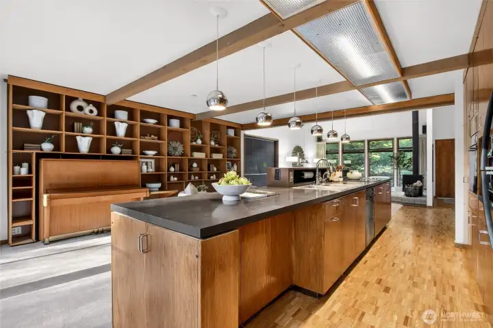 Open concept kitchen with restored hardwood floors and cabinetry