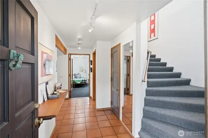 Entry w/ coat closet, down the hall to the full bath on the right, main floor bedroom strait on and kitchen and great room to the left.