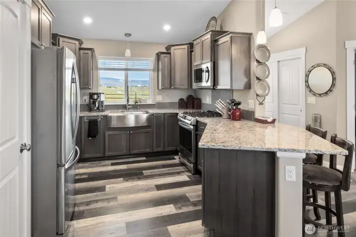 Light and Bright Kitchen with Granite Counter Tops, Stainless Appliances, Gas Cook top and Pantry. Views to enjoy!