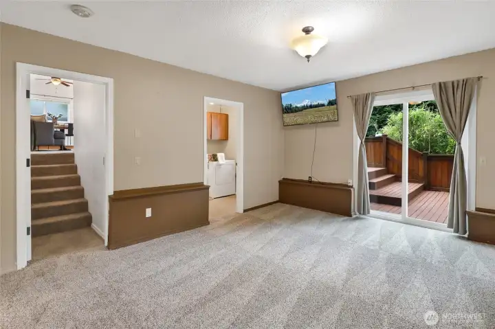 Lower level contains bonus room, laundry, 1/2 bath, access to garage and slider to the backyard.