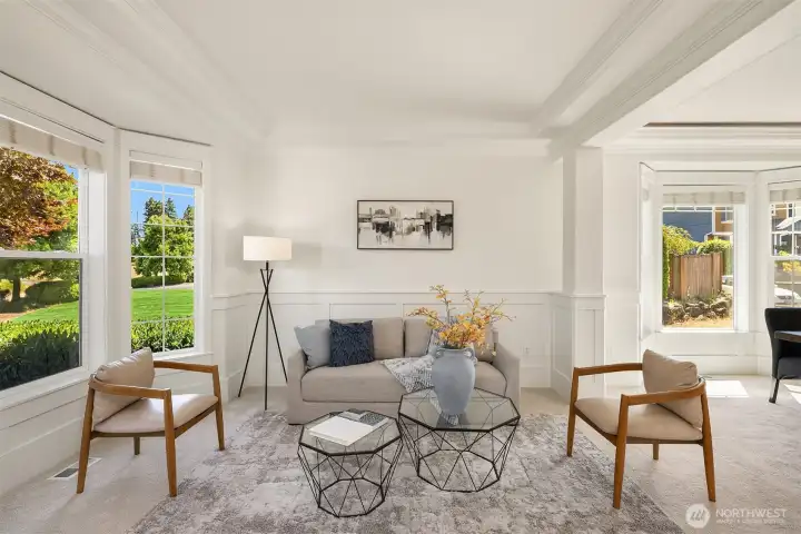 High ceilings in the living and dining room, with custom crown molding and wainscotting for an elevated design.