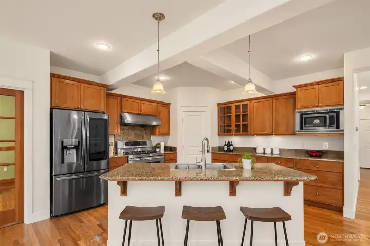 Large kitchen island and plenty of cabinet space for storage and countertop space for food prep.