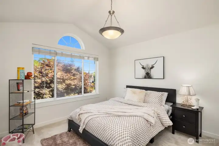 The second of three bedrooms, with vaulted ceilings and lots of natural light.