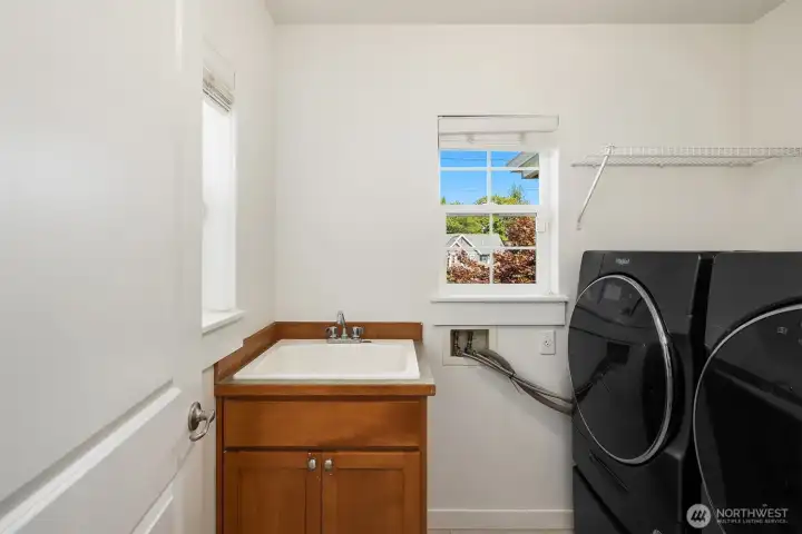 Upper floor laundry room for convenience with a utlity sink.