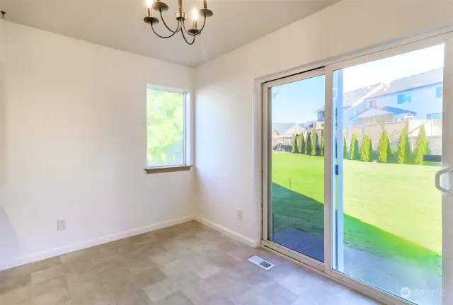 Informal dining w/ sliders to fully fenced yard