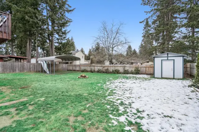 Huge fully fenced back yard.  Carport, fire pit, storage shed...