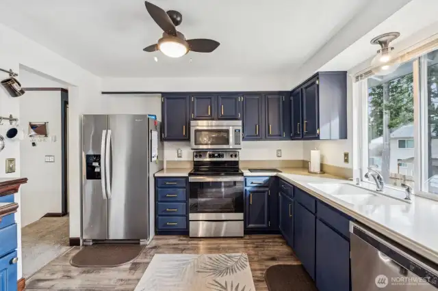 Large kitchen with newer stainless steel appliances.  You will love how the color scheme ties in from the living room fireplace.