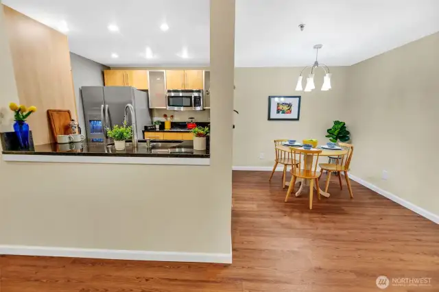 This photo shows another view of the open kitchen & dining rooms from the living room.