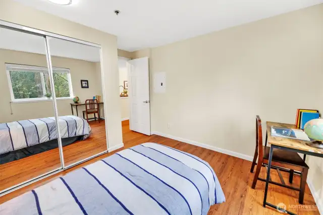 This photo shows the 2nd bedroom looking towards the closet. Updated mirrored doors enhance the feel and functionality of this room, making it look even larger and brighter while providing a practical storage solution.