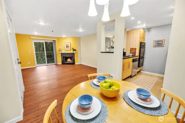 This photo shows the view from the dining room towards the living and kitchen.