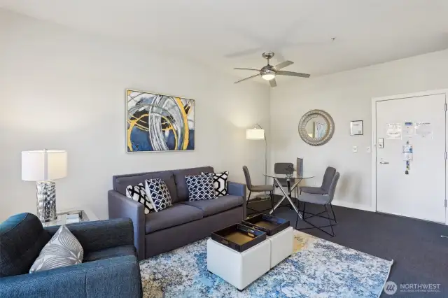 Living + Dining Area with Ceiling fan and carpet