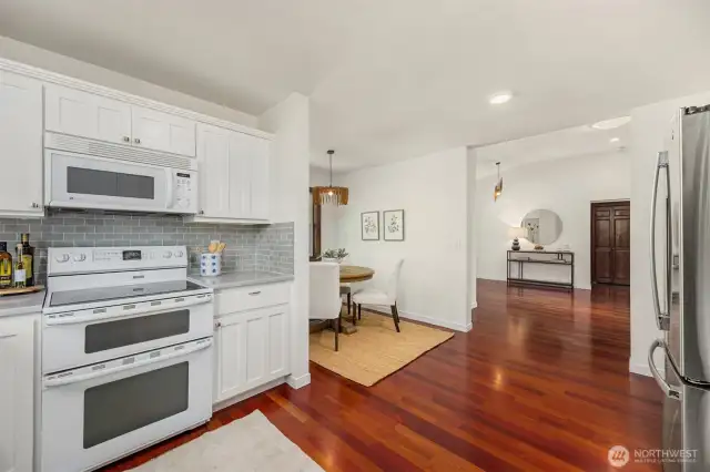 View from the kitchen to the dining and entryway with coat closet.