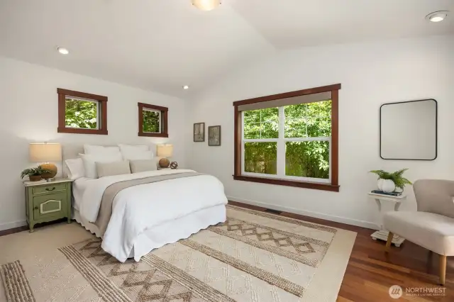 The spacious primary suite with garden view window and luxurious bathroom.