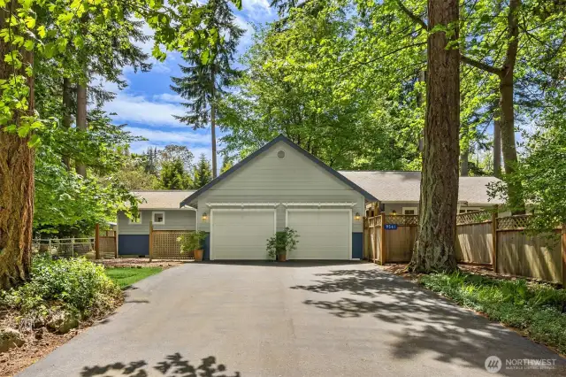 The two car garage has plenty of room for storage. The paved driveway is perfect for a basketball court!