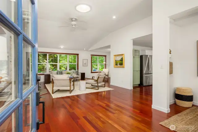The front entrance opens to the vaulted great room with cherry hardwoods.