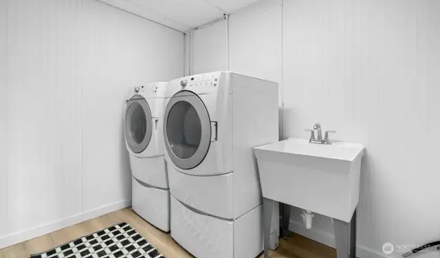 Laundry room on the lower level with newer front load machines.
