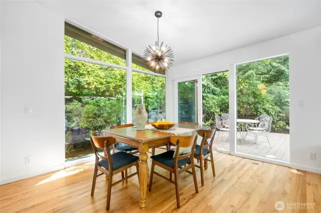 The dining room features floor to ceiling windows with an outlook over the private garden and yard, and easily connects to the large oversized deck perfect for grilling and al fresco entertaining.