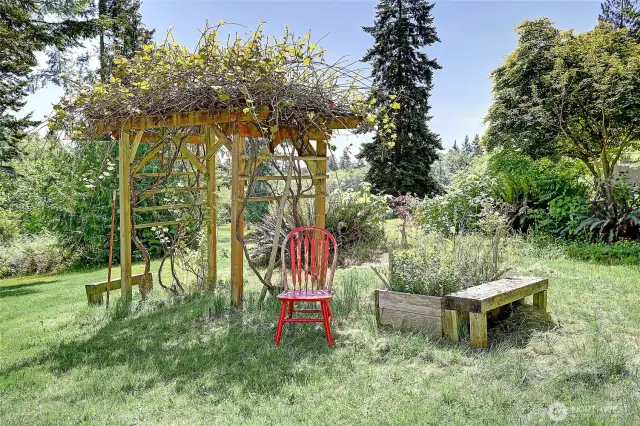 An arbor supports vines in this picturesque setting...