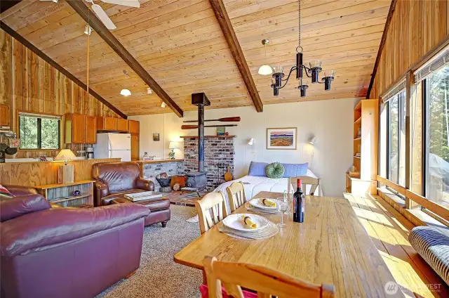 Built in storage and seating along the window line. Rustic elegance.  Real candle chandelier above a dining and game table.  All furniture may convey with purchase, making this move-in, rentable ready!