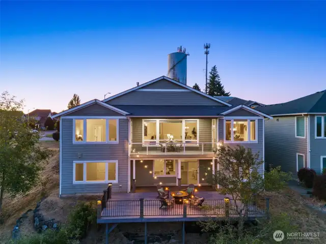 This twilight shot of the back of the home shows both main and lower levels. The Trex deck off the main and an expansive lower level deck are perfect for entertaining or enjoying the views.
