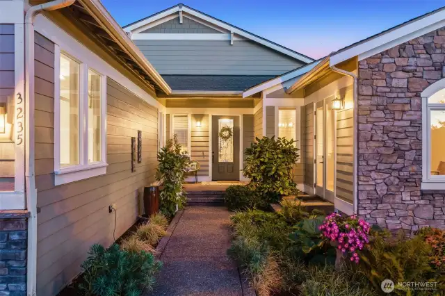 The covered front porch ahead and French doors to the 2nd bedroom OR home office on the right. A stunning photo at twilight...