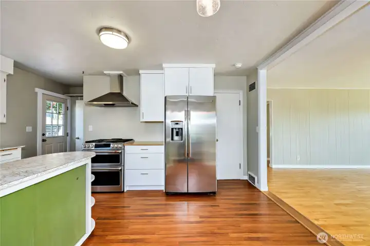Stainless steel refrigerator, gas range and handsome air vent.