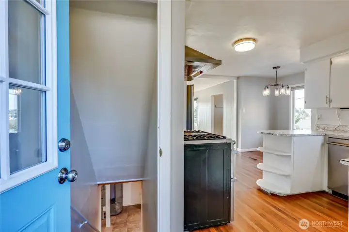 Off from the kitchen are stairs that lead downstairs to the basement.