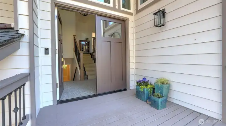 Wide porch and modern design double doors lead to this multi-level home.
