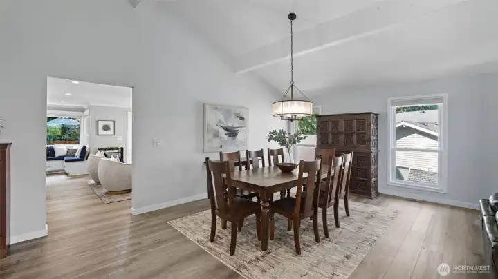 Open & spacious dining room with updated lighting leads to cozy family area