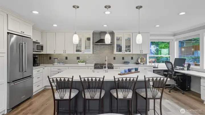 The kitchen showcases new cabinets with under-cabinet lighting, and stainless appliances.