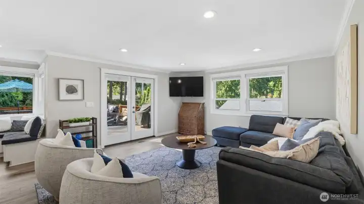 Family room leads to a new composite, 900 sqft TimberTech deck through the French doors.