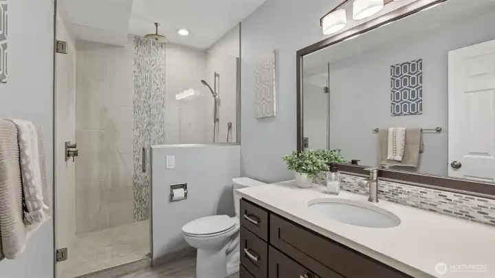 Updated 3/4 bathroom with walk-in shower, designer tile, quartz counter and new lighting