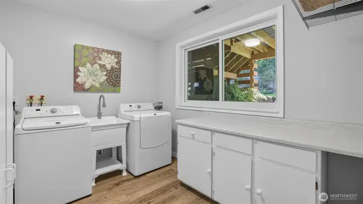 Large laundry room with storage and folding space
