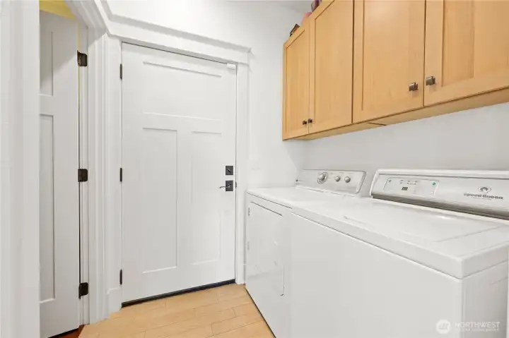 The laundry area with closet and garage entrance