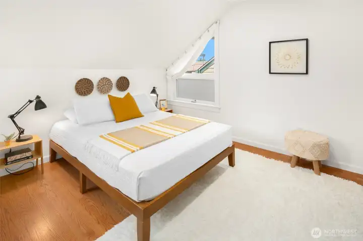 Second bedroom on upper floor features oak hardwoods with custom closet shelving as well.