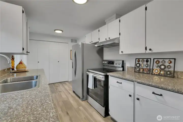 The kitchen is spotless and the laundry center is convenient with additional panty space...