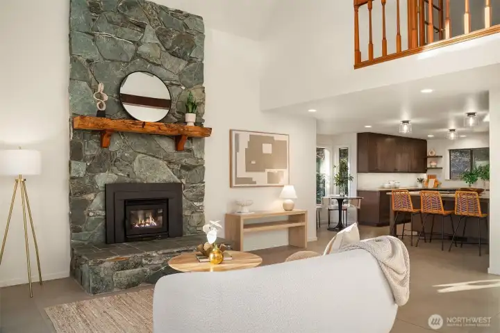 A stone surround fireplace with a new wood-burning insert in the great room creates an inviting ambiance for gatherings.