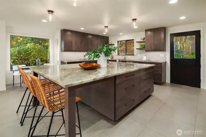New kitchen remodel with quartzite counters, custom cabinets with under cabinet lighting, and a dream island with ample seating.