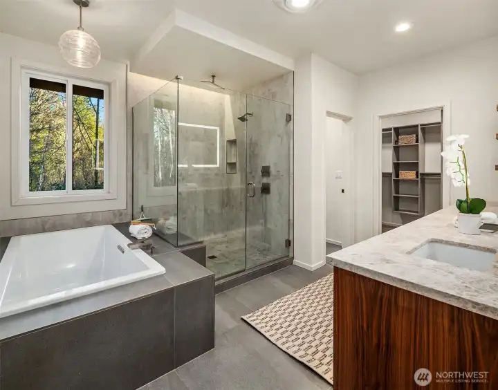 The primary bath is truly luxurious with a dual sink vanity, under cabinet lighting, lighted mirror, large soaking tub and separate shower.