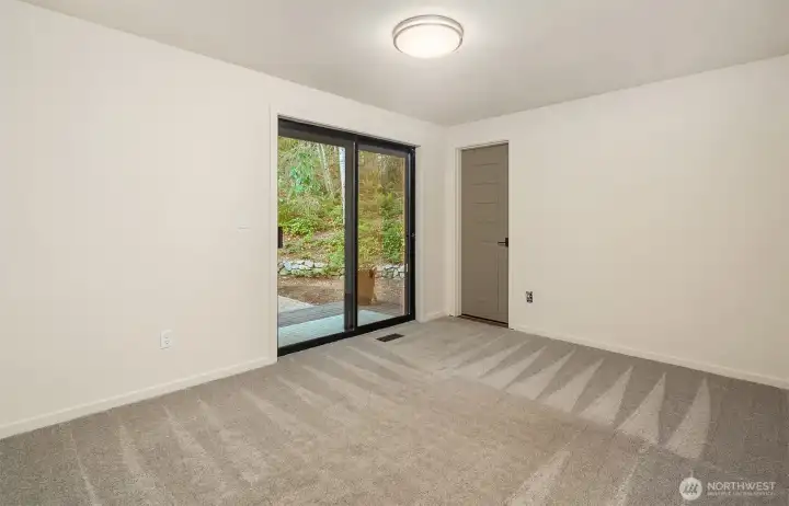 Additional bedroom with ensuite bath and slider to the outdoors.