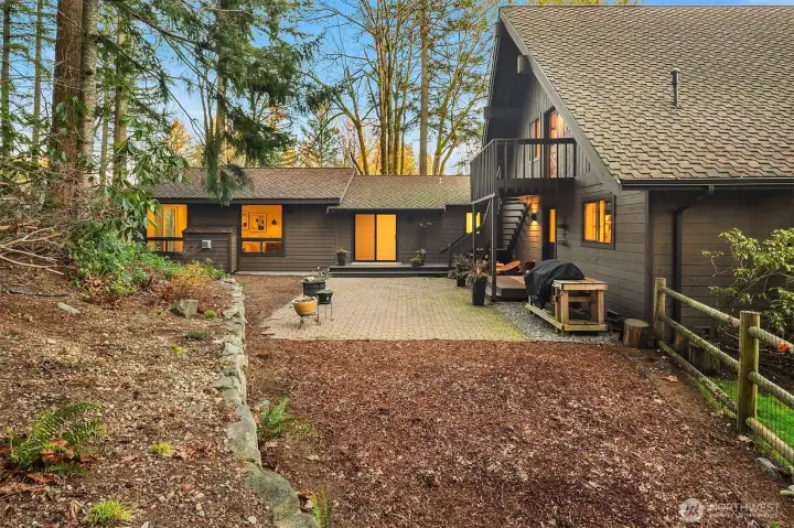 Back patio with access off the upper level bonus room, the kitchen.