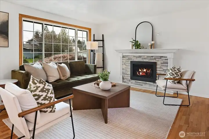 Light and bright living room with newer gas fireplace