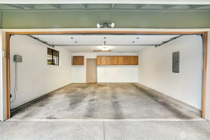 Roomy 2 car garage, new electric panel, and built in shelving.