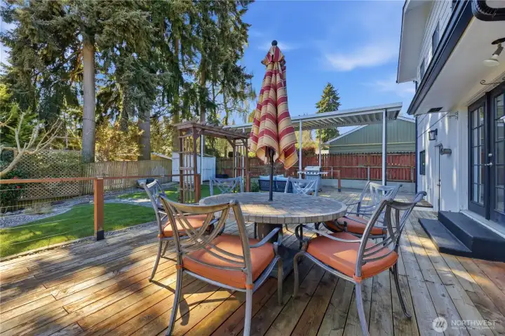 Large deck overlooking park-like yard with garden, greenhouse, chicken coup