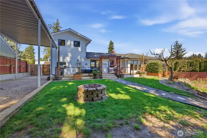 This yard has so much space plus a firepit!