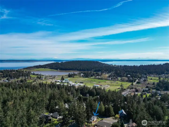 Location of home in bottom center. Settle into relaxed single-story living in this cheerful North Beach home, perfectly placed near parks, trails, and shoreline  adventures. Thoughtful updates run throughout the 3-bedroom, 2-bath floor plan, including a new 2025 roof, newer  appliances, and vinyl plank flooring that stands up beautifully to everyday life. Energy-conscious ductless mini-splits  provide efficient heating and cooling, while a freestanding wood stove in the living room adds warmth and character on  cooler days. Wide glass doors draw you out to the sunny, south-facing back deck—a natural extension of the living space for  outdoor dining, container gardening, or simply kicking back in the quiet. The private primary suite opens directly to this  deck as well, making it easy to step outside with your morning coffee or unwind under the stars. An attached two-car  garage, level corner lot with garden space, and available high-speed internet round out a home that is ready for bot