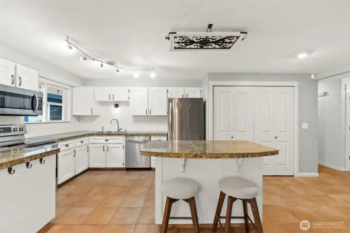 Open Kitchen with Granite Countertops, and Newer Appliances.