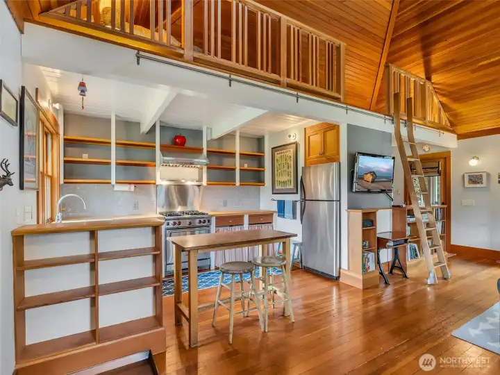 Kitchen space with loft above for additional storage or a sleeping space.