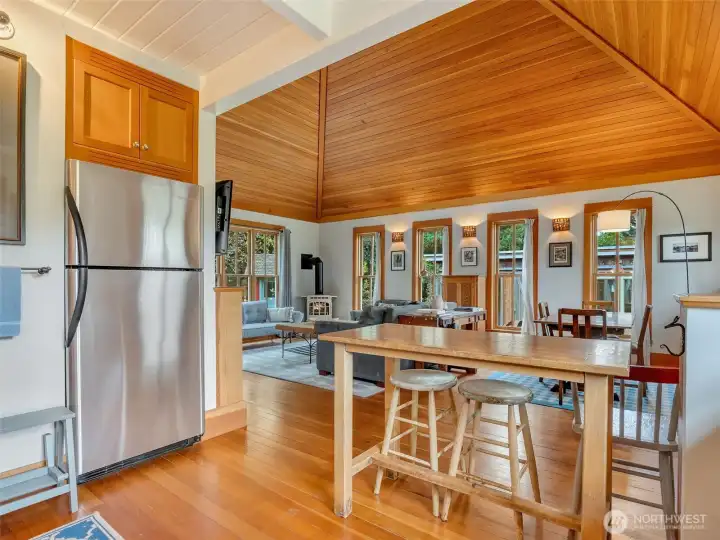 Stainless steel appliances, sitting bar, and open concept living.