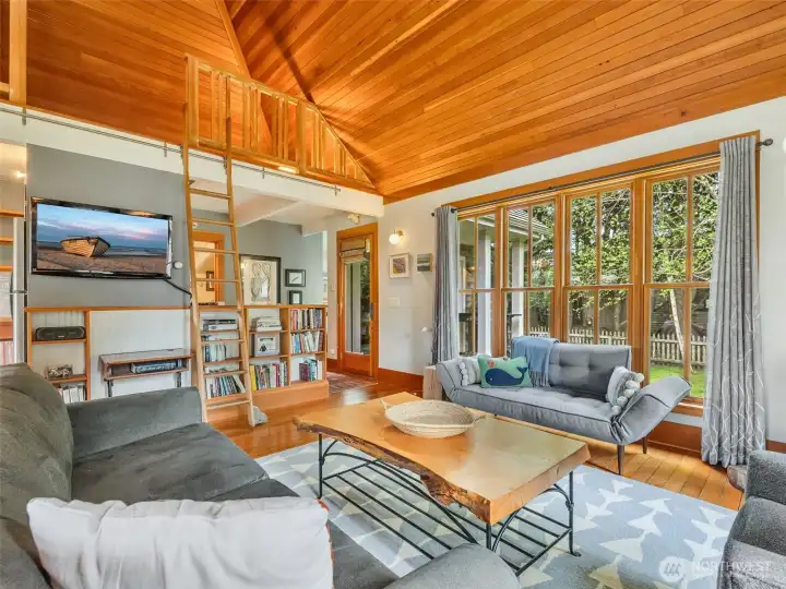 Living area with extensive built-ins and warm wood finishes. reclaimed wood ceiling from an old lumberjack bar in Oregon.